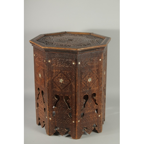 190 - A SYRIAN OCTAGONAL WOODEN TABLE, with mother of pearl inlay to the sides and carved panels of callig... 