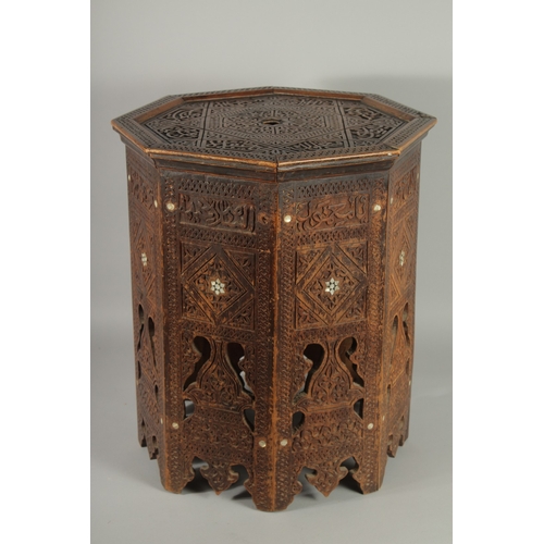 190 - A SYRIAN OCTAGONAL WOODEN TABLE, with mother of pearl inlay to the sides and carved panels of callig... 