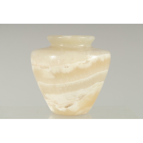 196 - AN EGYPTIAN CARVED ALABASTER VASE, 11cm high.