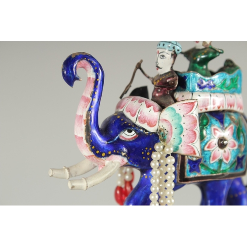 197 - AN EARLY 20TH CENTURY INDIAN BENARES ENAMELLED SILVER ELEPHANT, 10cm long.