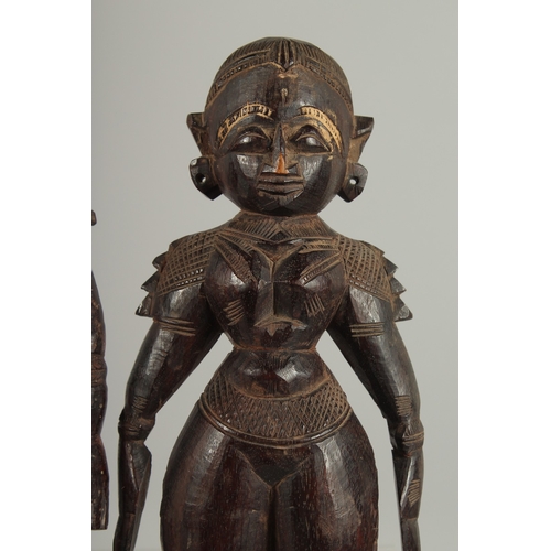 202 - TWO 19TH CENTURY SOUTH INDIAN -POSSIBLY TAMIL NADU CARVED WOOD FIGURES, 32cm and 30cm high.