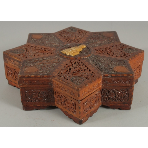 205 - A FINE 19TH CENTURY PERSIAN QAJAR ABADEH CARVED WOOD STAR-SHAPE BOX, the lid with carved and pierced... 