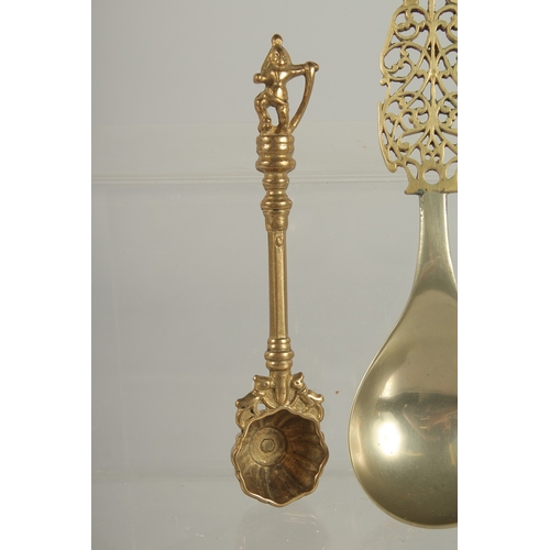 218 - A FINE LARGE PERSIAN OPENWORKED SPOON, together with another Indian brass spoon, (2).