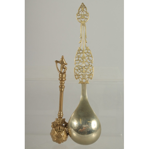 218 - A FINE LARGE PERSIAN OPENWORKED SPOON, together with another Indian brass spoon, (2).