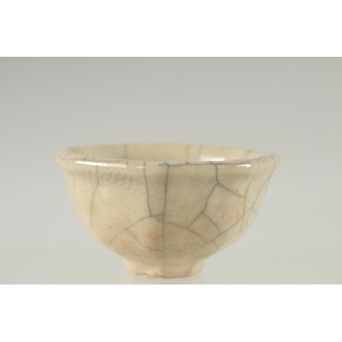 22 - A SMALL CHINESE OCTAGONAL CRACKLE GLAZE BOWL, 9cm wide.