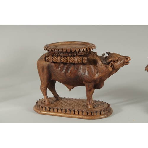 224 - TWO FINE 19TH CENTURY ANGLO INDIAN CARVED WOODEN BUFFALO SHAPED COASTERS / STANDS, each approx. 24cm... 