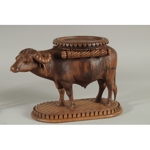 224 - TWO FINE 19TH CENTURY ANGLO INDIAN CARVED WOODEN BUFFALO SHAPED COASTERS / STANDS, each approx. 24cm... 