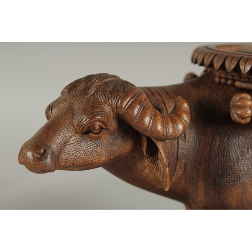 224 - TWO FINE 19TH CENTURY ANGLO INDIAN CARVED WOODEN BUFFALO SHAPED COASTERS / STANDS, each approx. 24cm... 