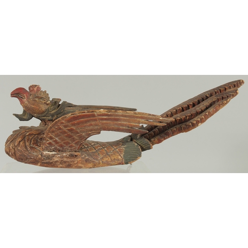 227 - AN 18TH-19TH CENTURY SOUTH EAST ASIAN LACQUERED CARVED WOODEN PHOENIX, possibly Thai, 30cm long.