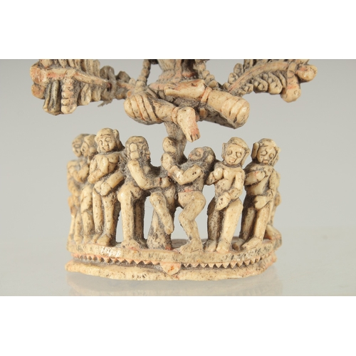 228 - A FINE 17TH-18TH CENTURY SOUTH INDIAN CARVED BONE FLUTING KRISHNA UNDER TREE, 10.5cm high.