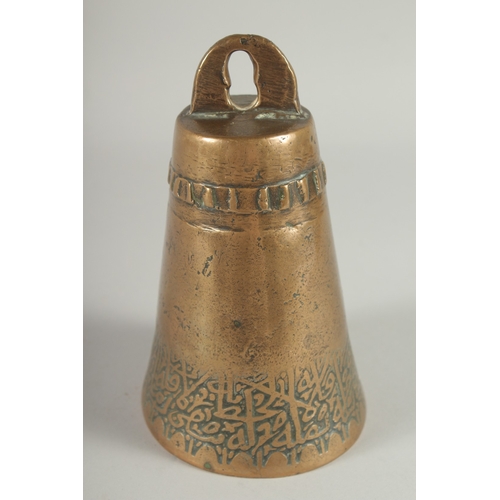 234 - AN 18TH CENTURY ISLAMIC BRASS BELL, with a band of calligraphic inscription, 17.5cm high.