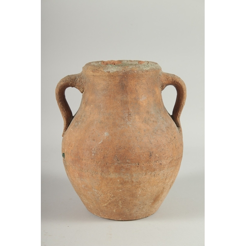 236 - A 10TH-12TH CENTURY IRANIAN TERRACOTTA TWIN HANDLE POT, with glazed green interior, 22.5cm high.