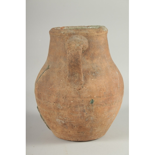 236 - A 10TH-12TH CENTURY IRANIAN TERRACOTTA TWIN HANDLE POT, with glazed green interior, 22.5cm high.