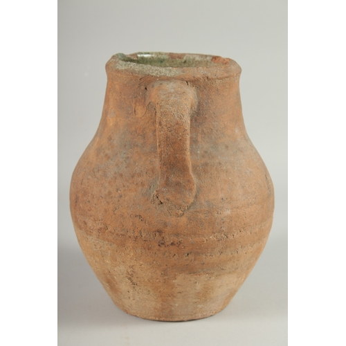 236 - A 10TH-12TH CENTURY IRANIAN TERRACOTTA TWIN HANDLE POT, with glazed green interior, 22.5cm high.