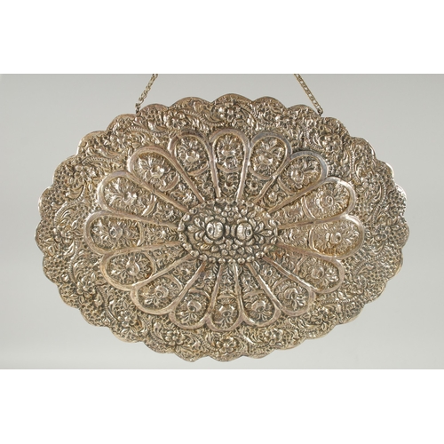 240 - A 19TH CENTURY OTTOMAN EMBOSSED SILVER MIRROR, with relief floral decoration and hanging chain, 30.5... 