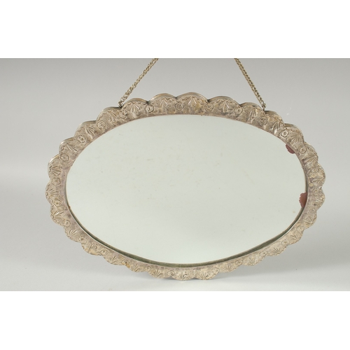 240 - A 19TH CENTURY OTTOMAN EMBOSSED SILVER MIRROR, with relief floral decoration and hanging chain, 30.5... 