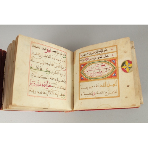 241 - A 19TH CENTURY MOROCCAN LEATHER BOUND DALA'IL AL KHAYRAT, with images of Mecca and Madina with medal... 