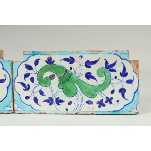 297 - A PAIR OF 18TH-19TH CENTURY MUGHAL NORTH INDIAN MULTAN POTTERY TILES, each 30cm x 15cm.