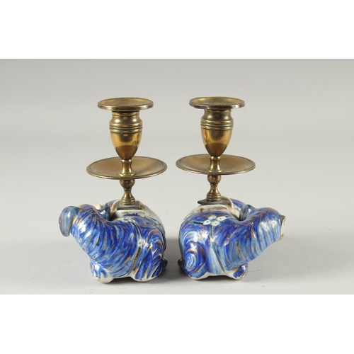 3 - A PAIR OF BLUE AND WHITE PORCELAIN BRASS MOUNTED FIGURAL CANDLESTICKS, the porcelain bases formed as... 