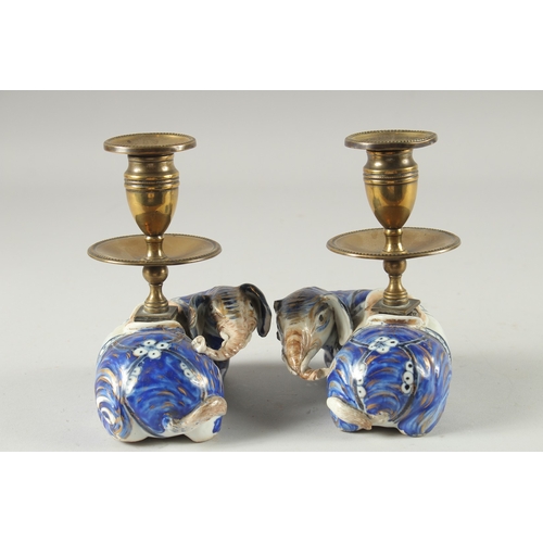 3 - A PAIR OF BLUE AND WHITE PORCELAIN BRASS MOUNTED FIGURAL CANDLESTICKS, the porcelain bases formed as... 