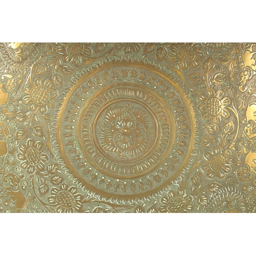 301 - A 19TH CENTURY INDIAN ENGRAVED BRASS TRAY INSET WITHIN A VELVET OVERLAID WOODEN FRAME, beautifully e... 