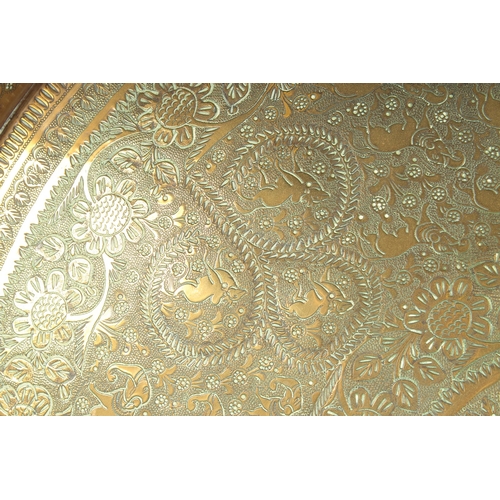 301 - A 19TH CENTURY INDIAN ENGRAVED BRASS TRAY INSET WITHIN A VELVET OVERLAID WOODEN FRAME, beautifully e... 