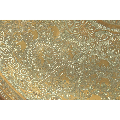 301 - A 19TH CENTURY INDIAN ENGRAVED BRASS TRAY INSET WITHIN A VELVET OVERLAID WOODEN FRAME, beautifully e... 