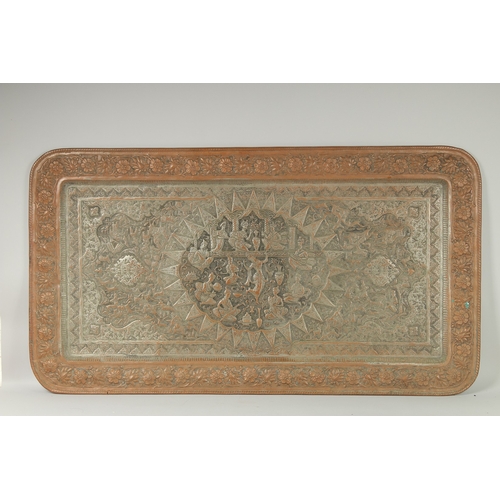 302 - A VERY LARGE PERSIAN ISFAHAN EMBOSSED AND CHASED TINNED COPPER RECTANGULAR TRAY, with a central reli... 