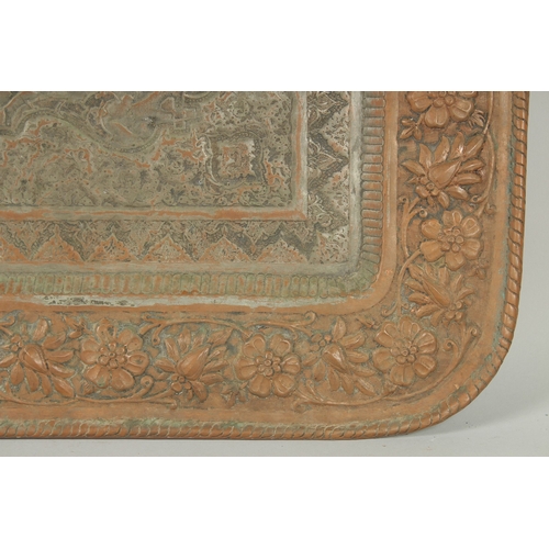 302 - A VERY LARGE PERSIAN ISFAHAN EMBOSSED AND CHASED TINNED COPPER RECTANGULAR TRAY, with a central reli... 