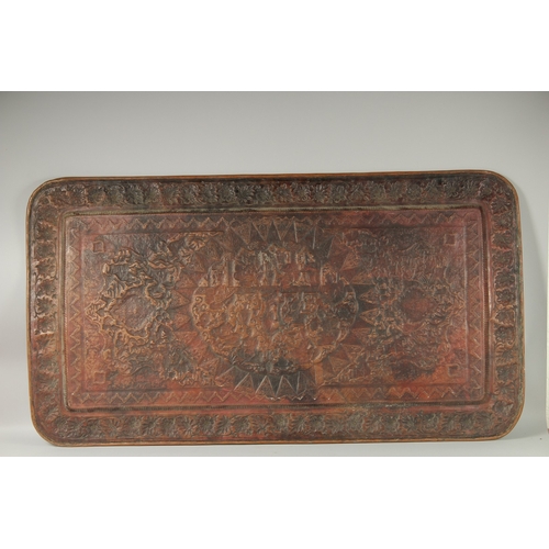 302 - A VERY LARGE PERSIAN ISFAHAN EMBOSSED AND CHASED TINNED COPPER RECTANGULAR TRAY, with a central reli... 