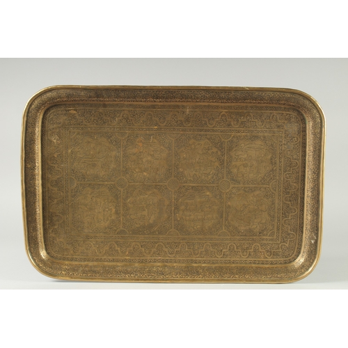 311 - A LARGE 19TH CENTURY PERSIAN QAJAR ENGRAVED BRASS TRAY, decorated with eight panels depicting variou... 