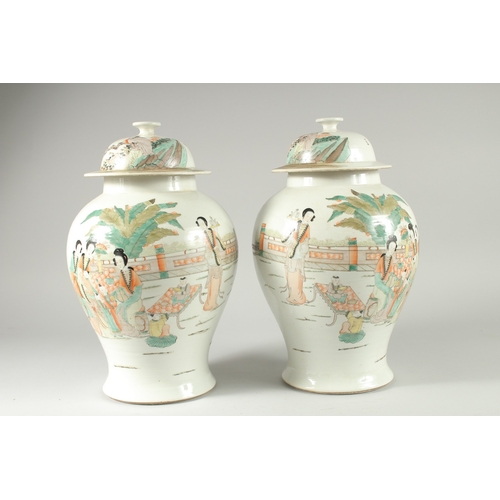 32 - A PAIR OF CHINESE FAMILLE VERTE PORCELAIN JARS AND COVERS, decorated with females and children in a ... 