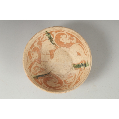 321 - A FINE RARE PERSIAN GARUS POTTERY BOWL - POSSIBLY 12TH-13TH CENTURY, with a camel design, 18cm diame... 