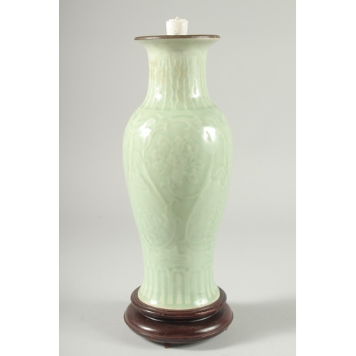 35 - A CHINESE CELADON GLAZE PORCELAIN VASE, mounted as a lamp to a wooden base, 34cm high.