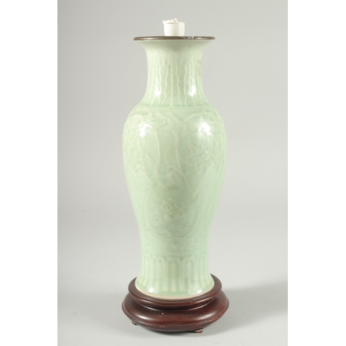 35 - A CHINESE CELADON GLAZE PORCELAIN VASE, mounted as a lamp to a wooden base, 34cm high.