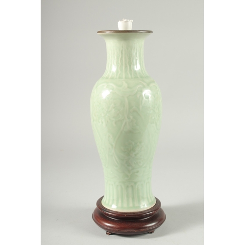 35 - A CHINESE CELADON GLAZE PORCELAIN VASE, mounted as a lamp to a wooden base, 34cm high.