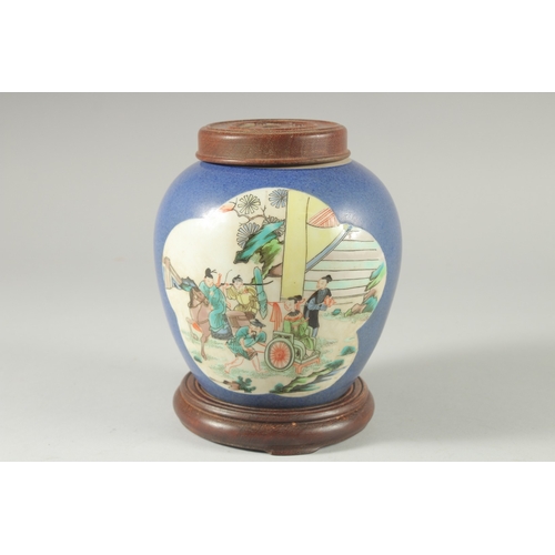 36 - AN EARLY 20TH CENTURY CHINESE BLUE GROUND FAMILLE VERTE PORCELAIN JAR, with wooden cover and stand.