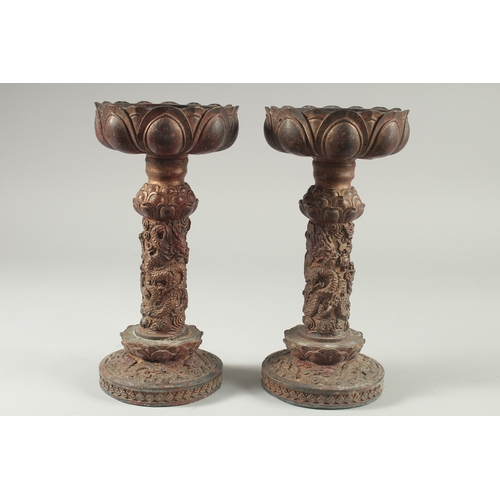 40 - A PAIR OF CHINESE ARCHAIC STYLE GILT BRONZE CANDLESTICKS, 28cm high.