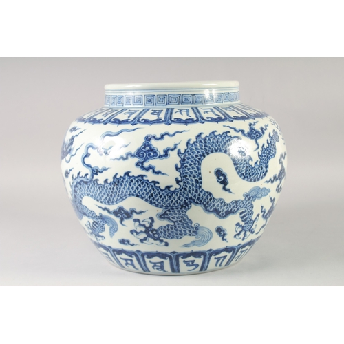 468 - A LARGE CHINESE BLUE AND WHITE PORCELAIN JARDINIERE, painted with dragons and bands of characters, b... 