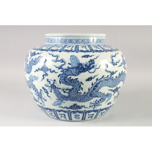 468 - A LARGE CHINESE BLUE AND WHITE PORCELAIN JARDINIERE, painted with dragons and bands of characters, b... 