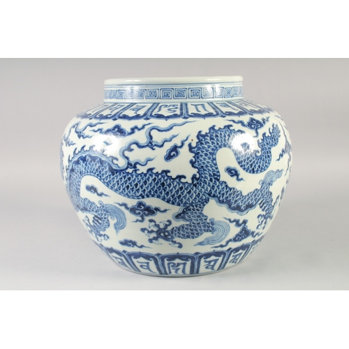 468 - A LARGE CHINESE BLUE AND WHITE PORCELAIN JARDINIERE, painted with dragons and bands of characters, b... 