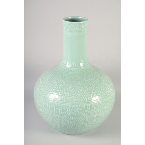 470 - A VERY LARGE CHINESE CELADON GLAZED PORCELAIN VASE, with carved decoration and six-character mark to... 