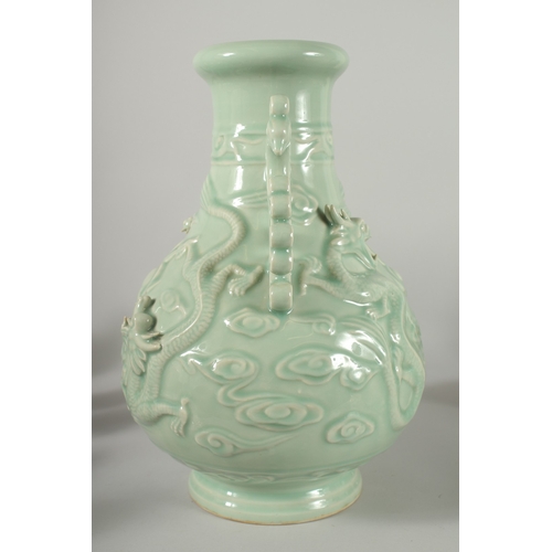 471 - A LARGE CHINESE CELADON GLAZE TWIN HANDLE VASE, with moulded relief dragons, mark to base, 39cm high... 