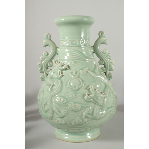 471 - A LARGE CHINESE CELADON GLAZE TWIN HANDLE VASE, with moulded relief dragons, mark to base, 39cm high... 