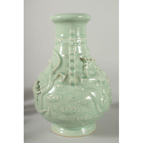 471 - A LARGE CHINESE CELADON GLAZE TWIN HANDLE VASE, with moulded relief dragons, mark to base, 39cm high... 