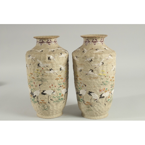 5 - AN UNUSUAL PAIR OF JAPANESE POTTERY VASES, with enamel painted decoration of cranes and flora, inscr... 