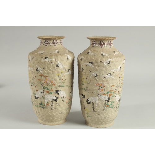 5 - AN UNUSUAL PAIR OF JAPANESE POTTERY VASES, with enamel painted decoration of cranes and flora, inscr... 