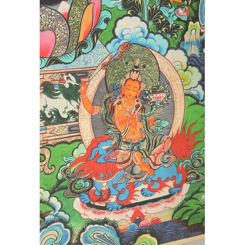 76 - A TIBETAN THANGKA MOUNTED ON PAPER.