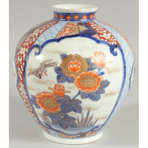 82 - A FINE JAPANESE IMARI PORCELAIN BULBOUS VASE, beautifully painted with panels of birds and native fl... 