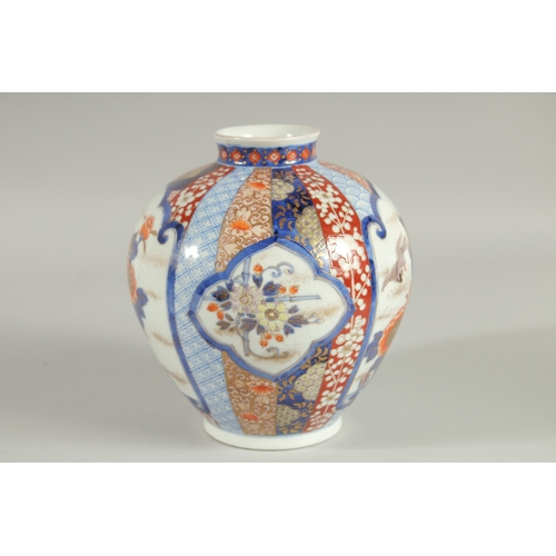 82 - A FINE JAPANESE IMARI PORCELAIN BULBOUS VASE, beautifully painted with panels of birds and native fl... 